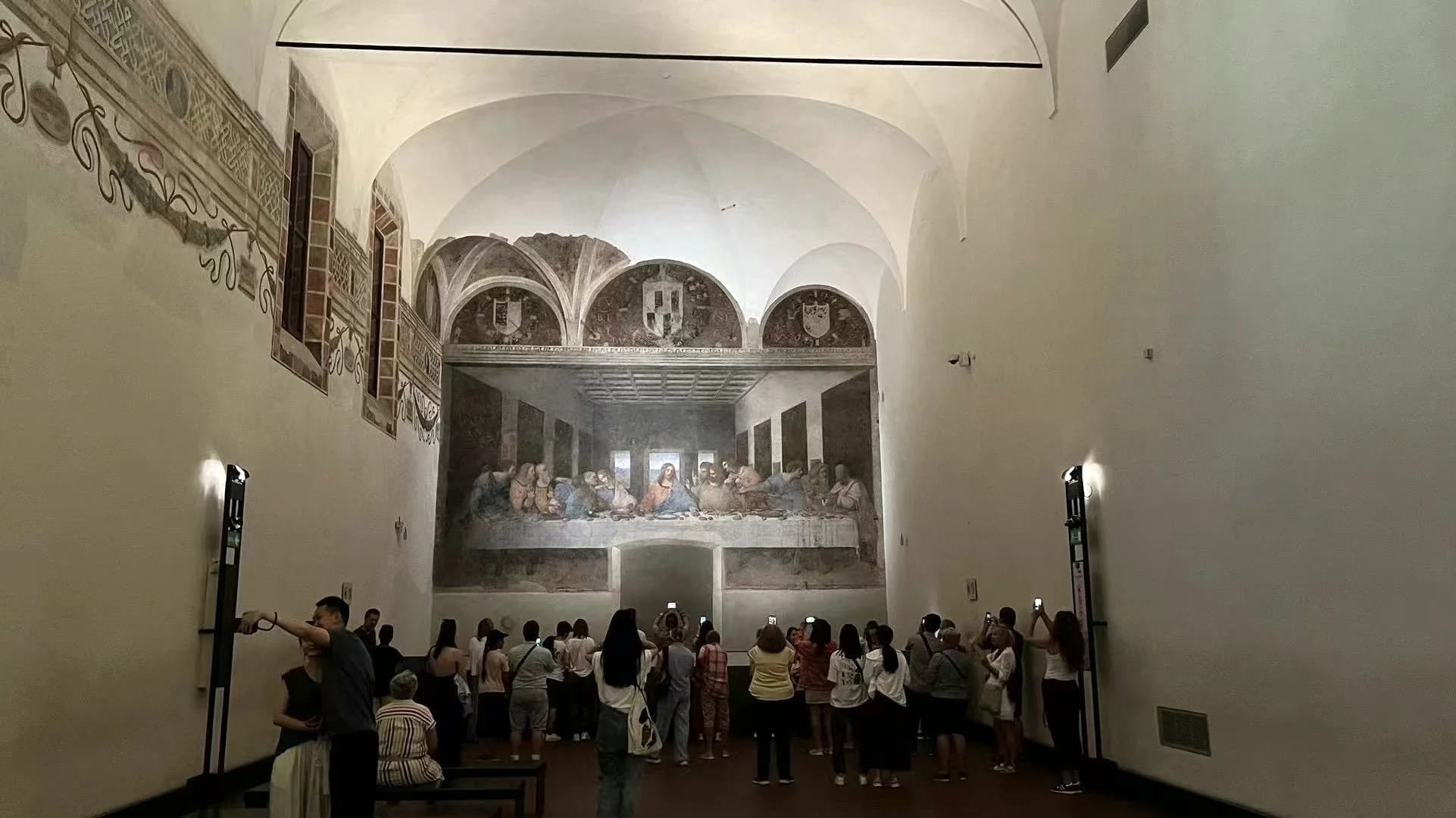 Visitors viewing The Last Supper inside the original vaulted refectory